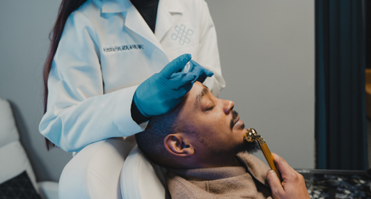 Patient receiving a forehead injection during a Botox cosmetic consultation at a medical clinic.